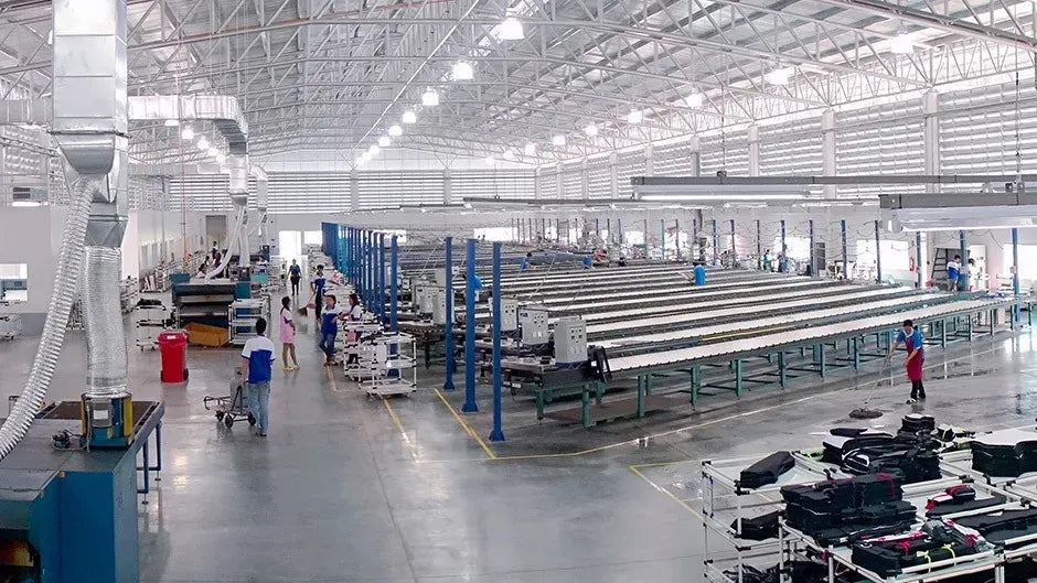 Factory interior with conveyor belts, workers, and machinery