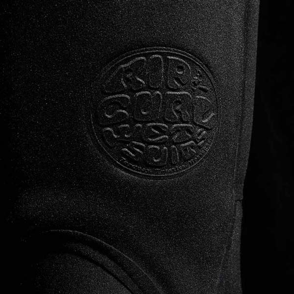 Close-up of a black wetsuit logo on a dark background