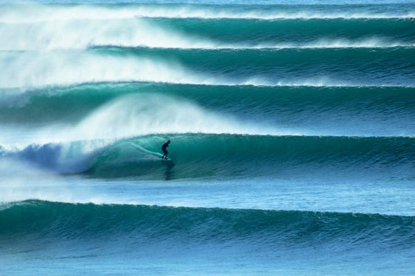 Surfer riding a large wave in the ocean