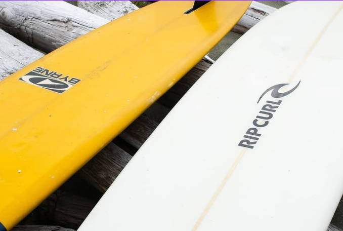 A yellow and white surfboards
