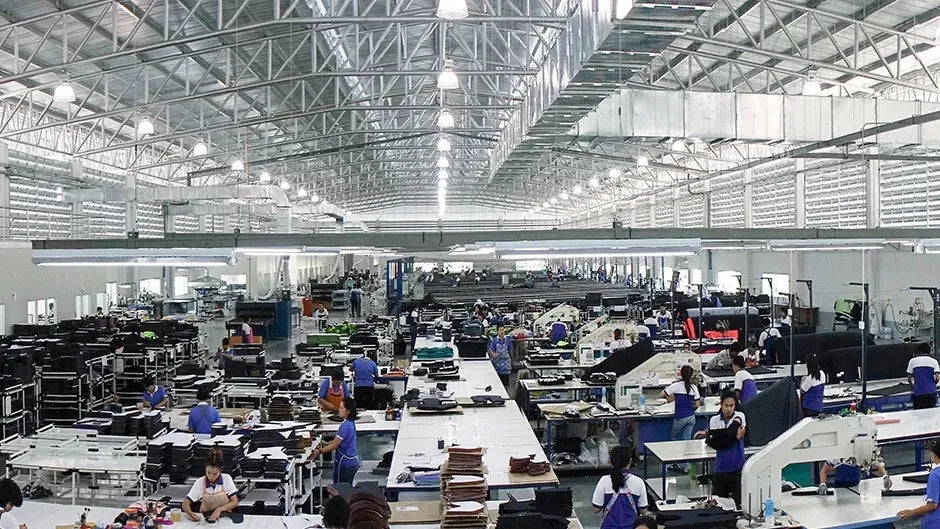 Large industrial or manufacturing facility with multiple workstations and employees.